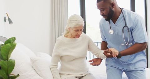 Compassionate Nurse Assisting Elderly Woman at Home in Slow Motion - Download Free Stock Images Pikwizard.com