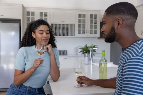 Couple Enjoying Wine and Conversation in Modern Kitchen Setting