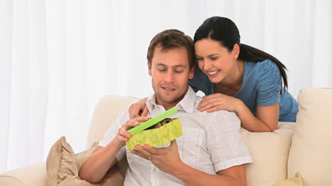 Happy Couple Sharing a Gift Moment at Home