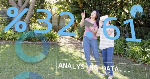 Daughter guiding mother using ar tablet and vr headset in sunlit backyard analyzing data