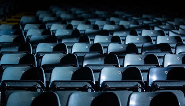 Empty stadium seats in rows highlighting symmetry and geometric repetition