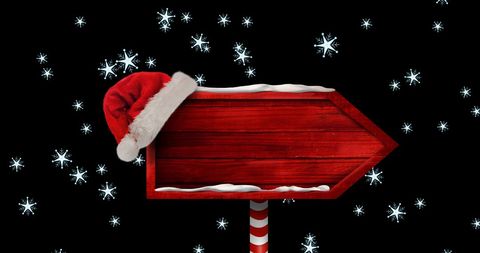 Wooden Sign with Santa Hat Amid Falling Snowflakes