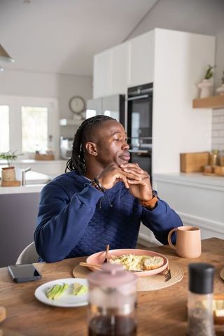 Man enjoying breakfast at home in modern kitchen ambiance