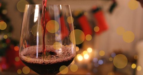 Festive Glass of Red Wine with Christmas Decorations