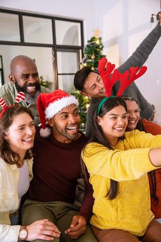 Excited Friends Enjoy Christmas Party with Festive Accessories