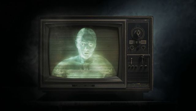 Vintage tv displays surreal green hologram in dark room