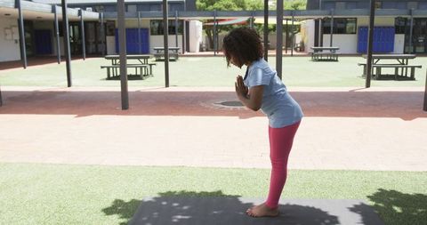 Young Girl Practicing Yoga in Outdoor Schoolyard