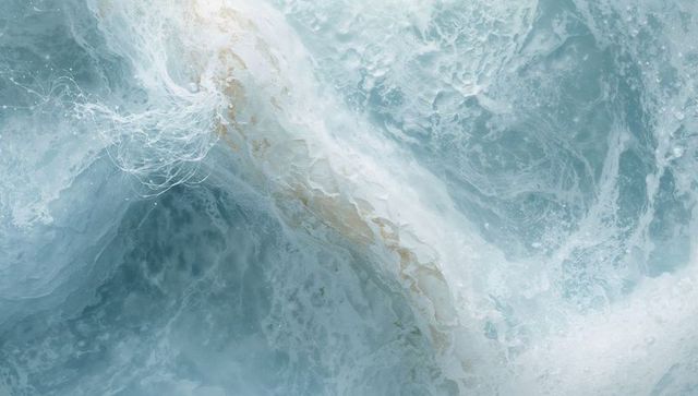 Turquoise ocean currents swirling with foam and bubbles abstract aerial water texture
