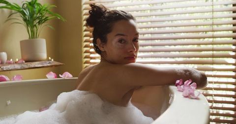 Serene self-care moment with rose petal bath