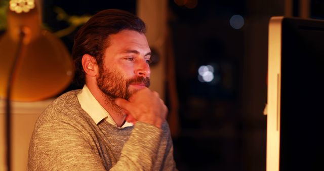 Caucasian casual businessman using computer working late in office at night with copy space - Download Free Stock Photos Pikwizard.com