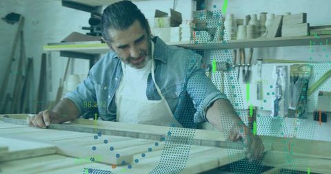 Skilled woodworker using ruler on wooden frame in workshops