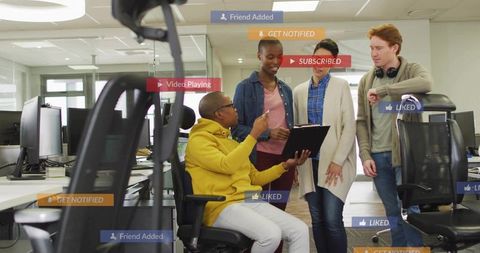 Team collaborating around tablet in open-plan office with social overlays