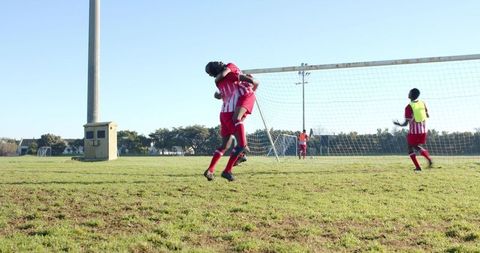 Dynamic soccer celebration: athletes embracing victory on field
