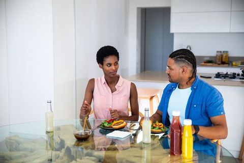 Diverse Couple Enjoying Meal and Conversation at Home