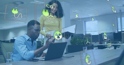 Collaborating on renewable energy data with holographic icons in modern office workspace