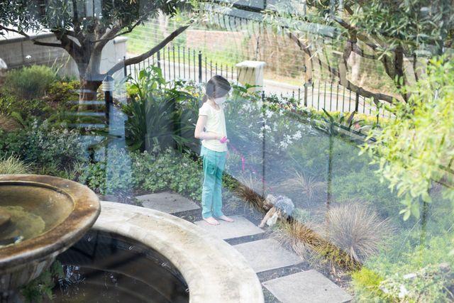 Little Girl Walking Dog in Lush Backyard Garden - Download Free Stock Photos Pikwizard.com