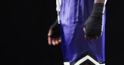 Boxer with wrapped hands preparing for intense training