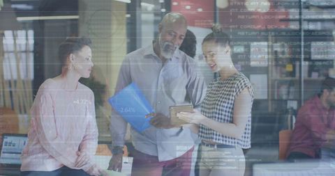 Colleagues collaborating with digital financial data overlays