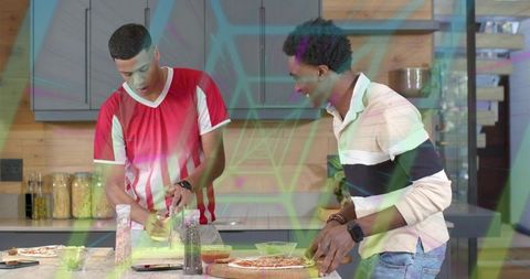 Friends preparing pizza at modern kitchen island grating cheese and slicing pizza together