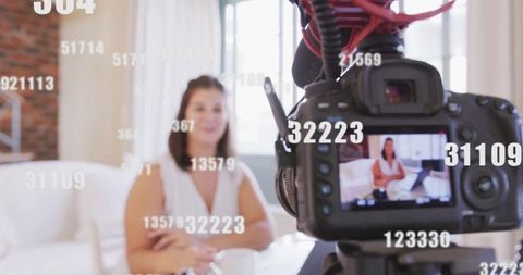 Vlogger speaking on camera at home office with microphone setup