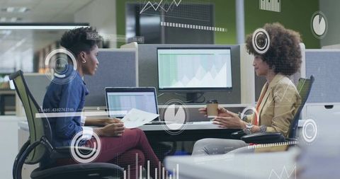 Colleagues Discussing Data Trends and Analysis in Modern Office