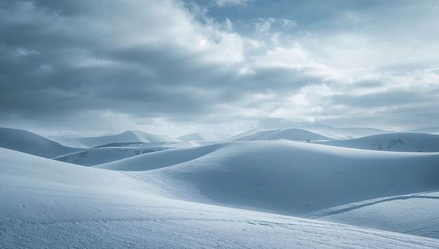 Serene Winter Hills Under Moody Grey Sky