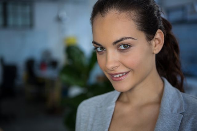 Businesswoman smiling at camera in office