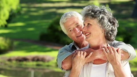 Happy Mature Couple Embracing in Serene Countryside