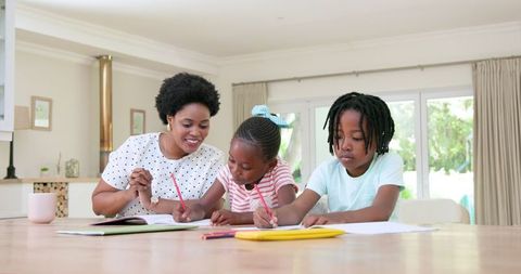 Mother Helping Children with Homework at Table