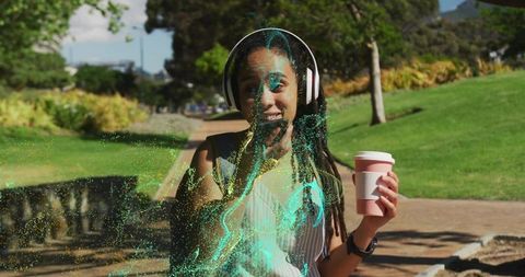 Woman surprised by magical particles while enjoying coffee in park