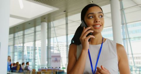 Confident Businesswoman on Phone Call in Modern Office Lobby