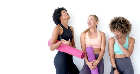 Diverse Women in Sportswear Sharing a Fun Moment with Yoga Mats - Download Free Stock Images Pikwizard.com