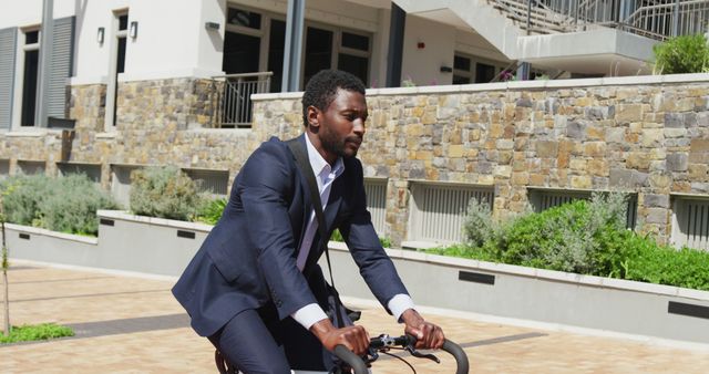 Businessman cycling to work in urban area, representing eco-friendly transportation and modern urban lifestyle. Ideal for illustrating topics on sustainable commuting, active lifestyle, urban living, or professional daily routines.