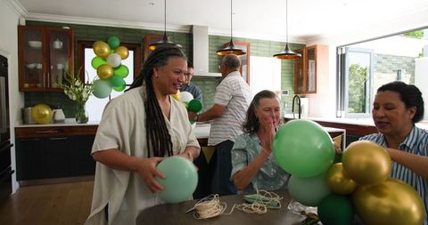 Senior Friends Collaborating on Festive Balloon Decorations