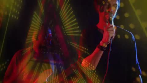 Rock Band Performing with Dramatic Geometric Light Effects on Stage