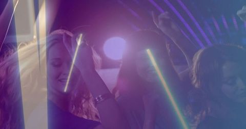 Neon club night: women dancing under purple and blue laser lights and lens flares