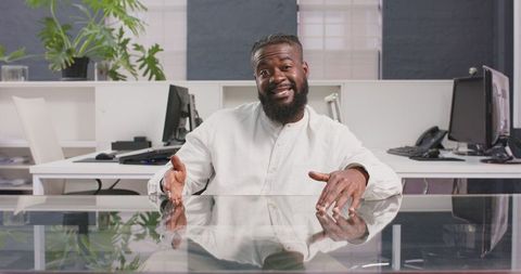 Confident businessman discussing ideas at office desk