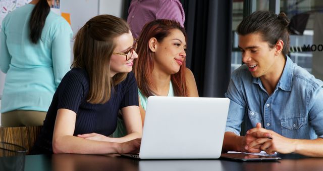 Diverse Group of Young Professionals Working Together on Laptop - Download Free Stock Images Pikwizard.com