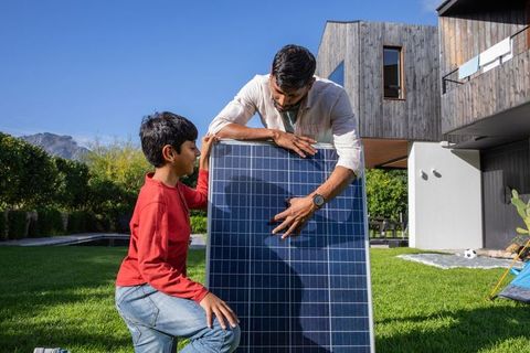 Father Teaching Son About Solar Panels in Sustainable Home Setting