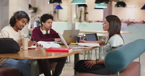 Studying Together in Campus Lounge Using Laptops, Tablets and Notebooks for Group Work
