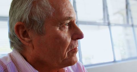 Side View of Introspective Senior Man at Nursing Home