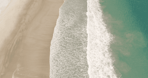 Seamless meeting of sand and waves along seashore