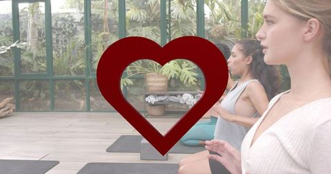 Practicing Heart-Centered Breathwork in Sunlit Greenhouse Yoga Class