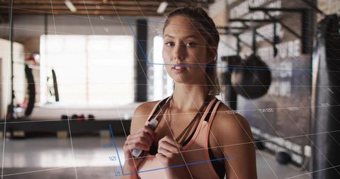 Woman in Gym Setting with Digital Overlay Emphasizing Fitness