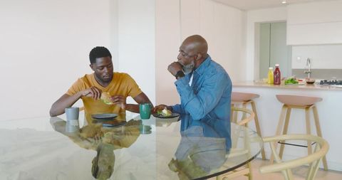 Father and Son Enjoying Homestyle Meal in Modern Kitchen