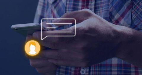 Hands holding smartphone and typing with chat bubble and glowing avatar overlay