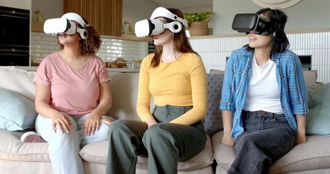 Diverse women in vr exploring technology at home