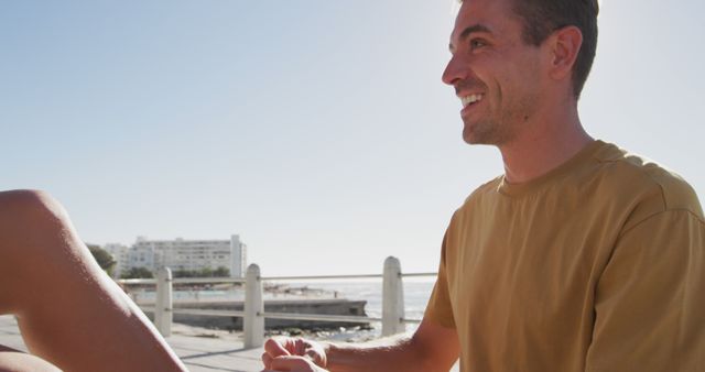 Happy man smiling on sunny day by seashore - Download Free Stock Images Pikwizard.com