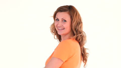 Smiling Woman Posing in Orange Shirt in Studio