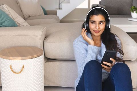 Relaxed South Asian Woman Enjoying Music at Home